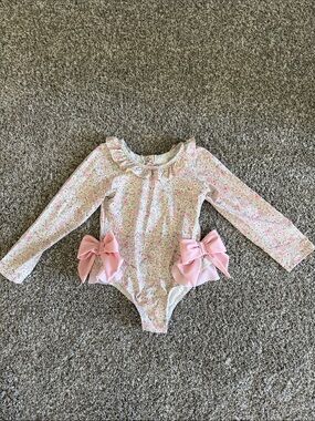 Long-Sleeve Pink Floral One-Piece Swimsuit with Decorative Bows